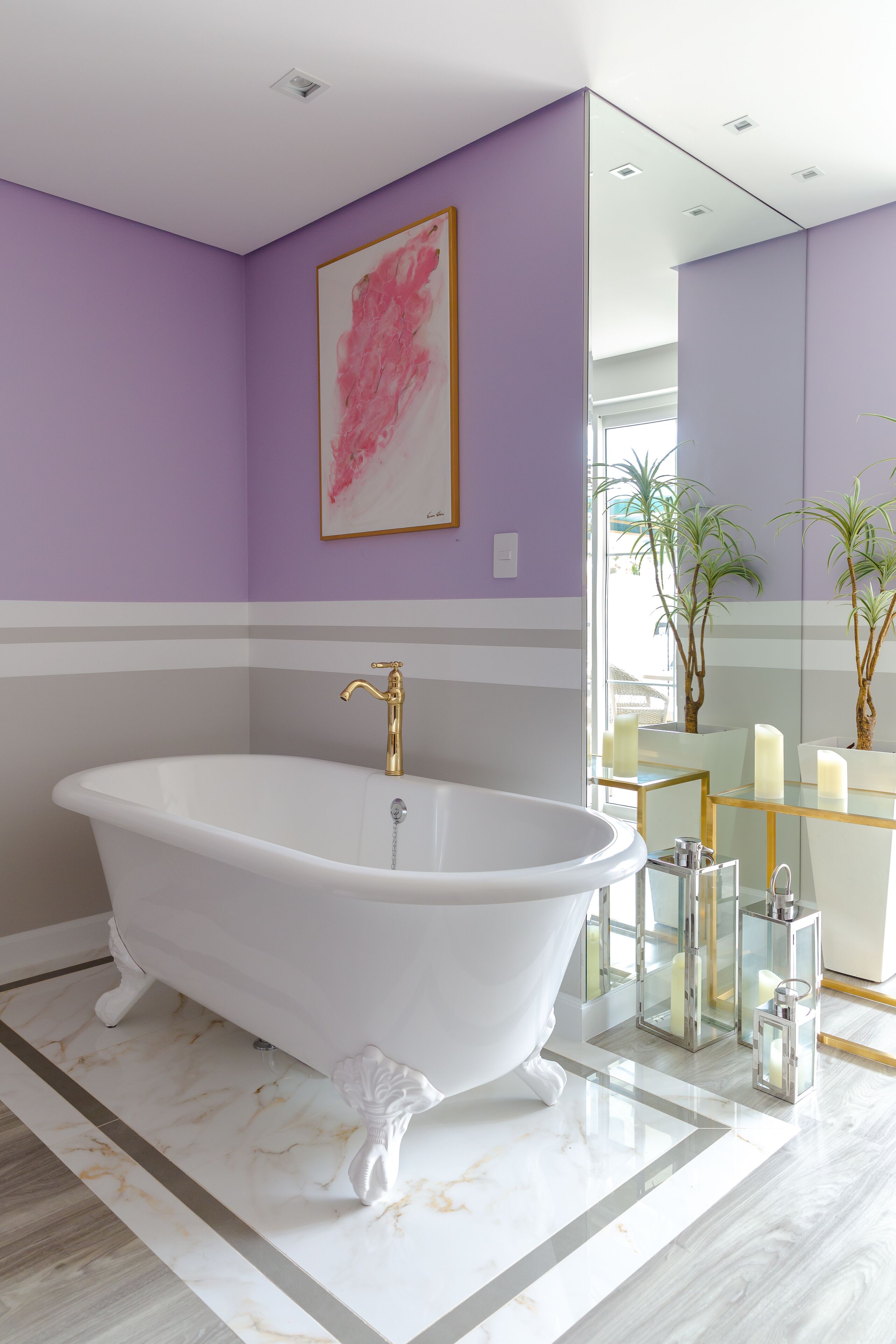 A modern bathroom with a freestanding bathtub, a large mirror, and a glass vanity.