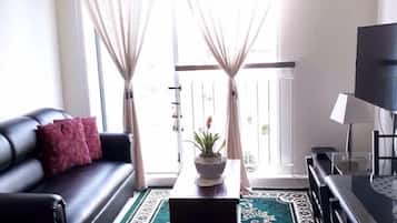 Standard Condo, Multiple Beds, Garden View | Living area | Flat-screen TV