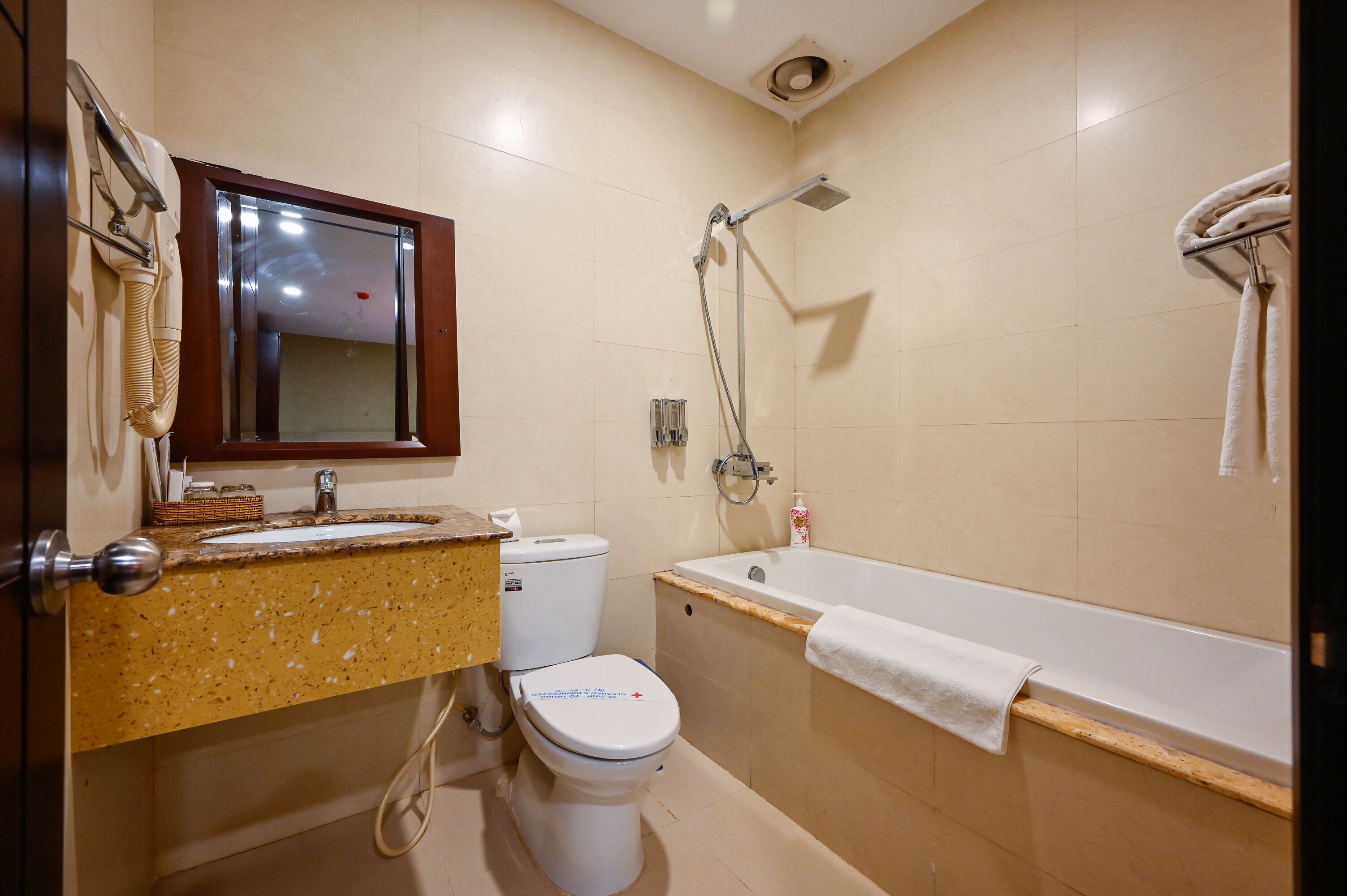 A bathroom with a sink, toilet, and bathtub.