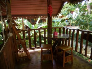 Enjoy dining or socializing on this charming deck surrounded by lush greenery.
