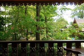 Enjoy the serene views from this deck overlooking a lush garden.