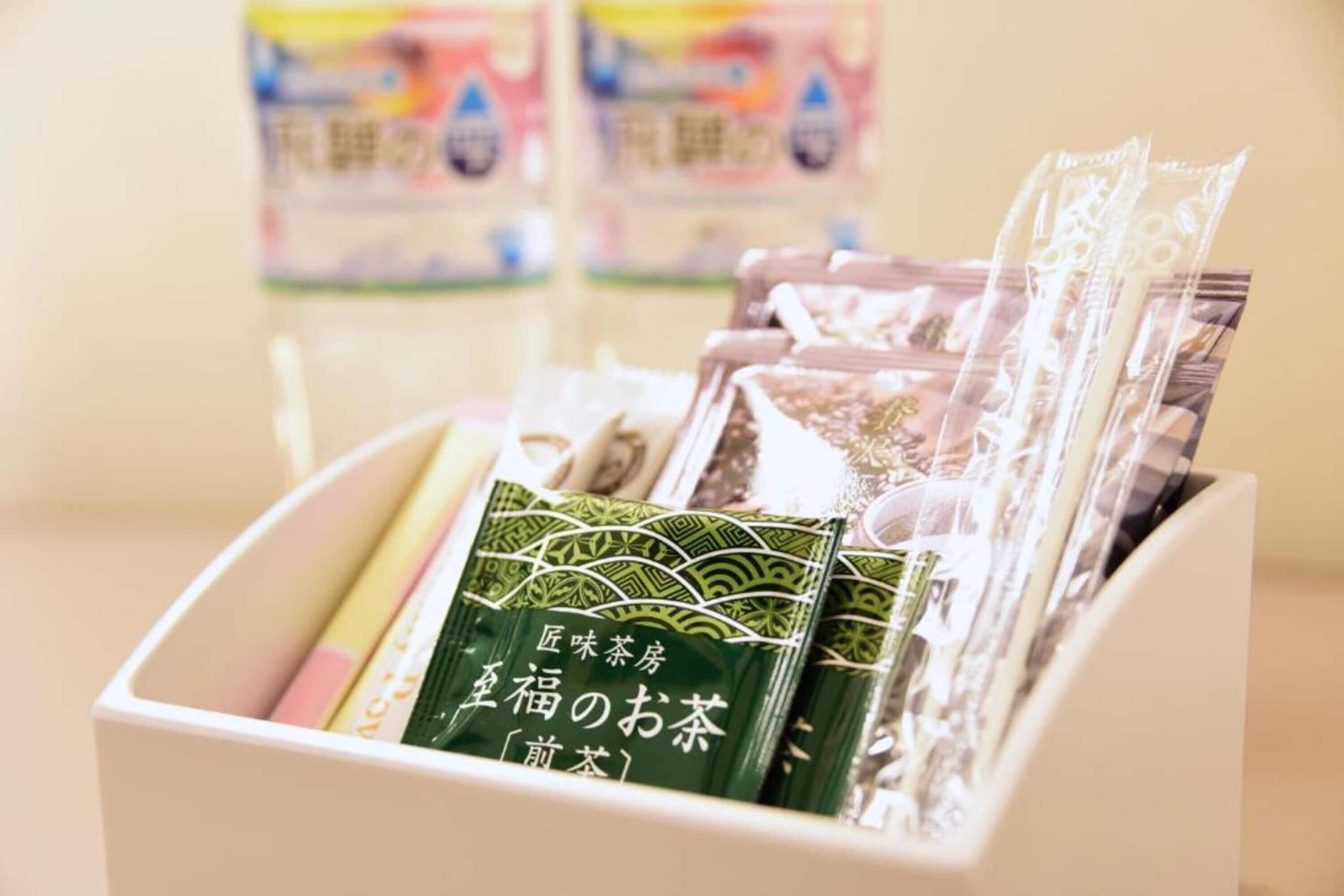 A box containing various tea packets and a few pencils.
