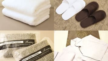 A set of white towels, a pair of brown slippers, and two body wash towels.