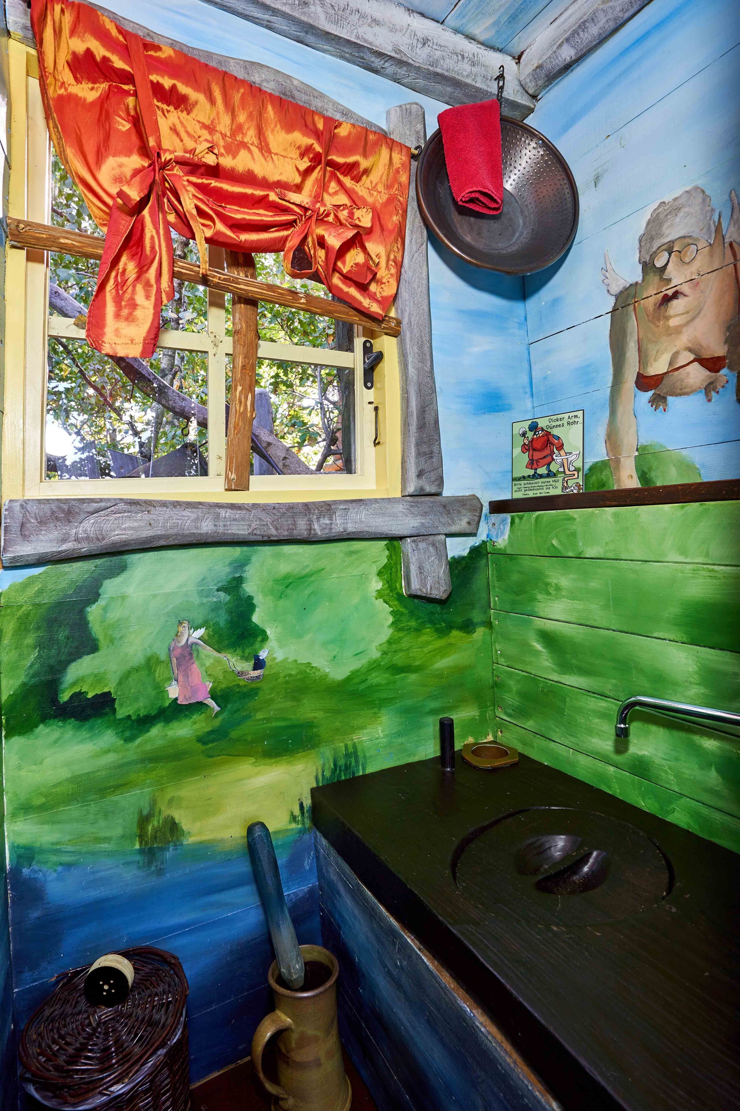 A room with a window, a sink, a red cloth, a painting of a woman, and a wall with a green landscape.