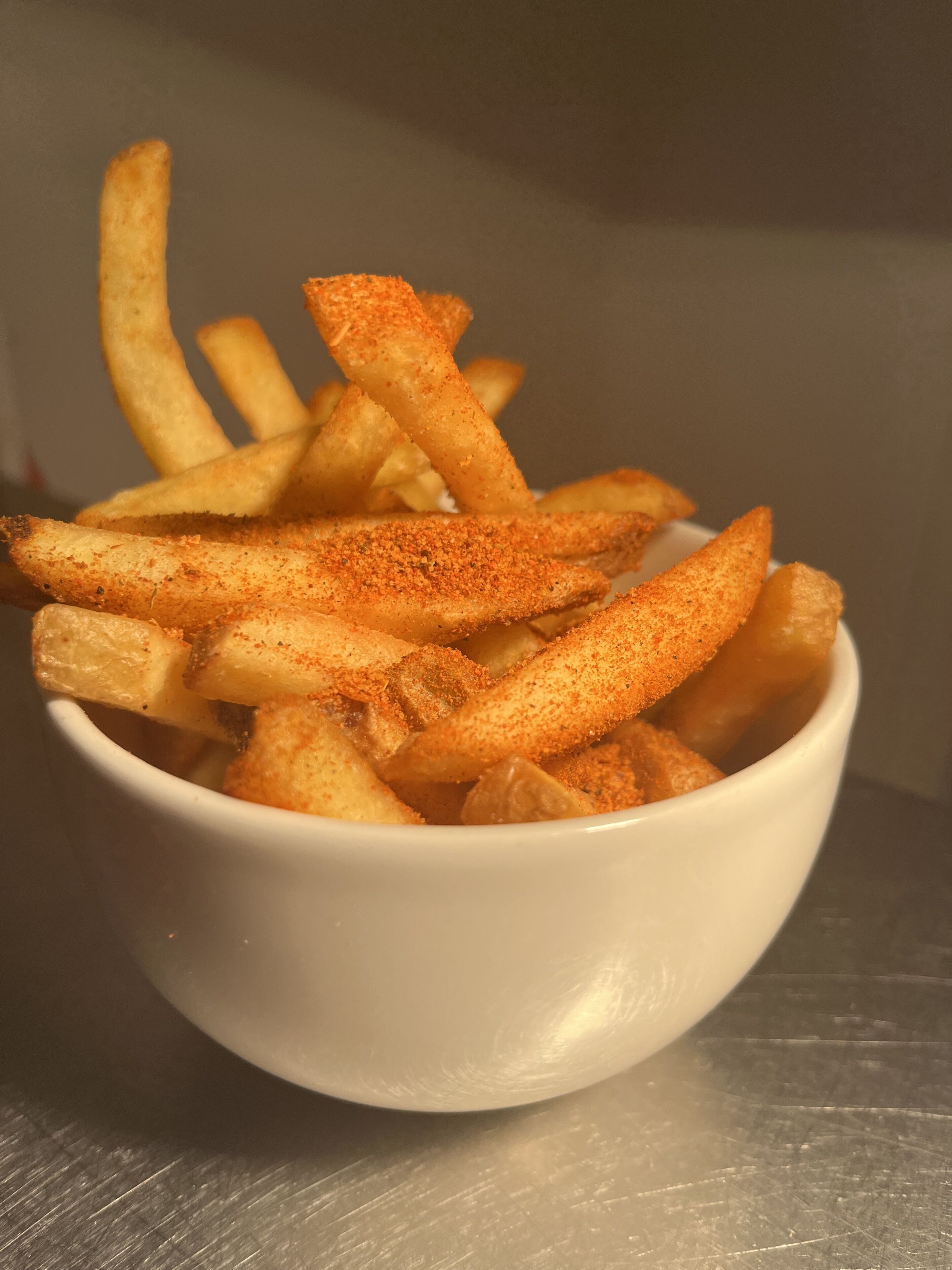 A bowl of seasoned fries.