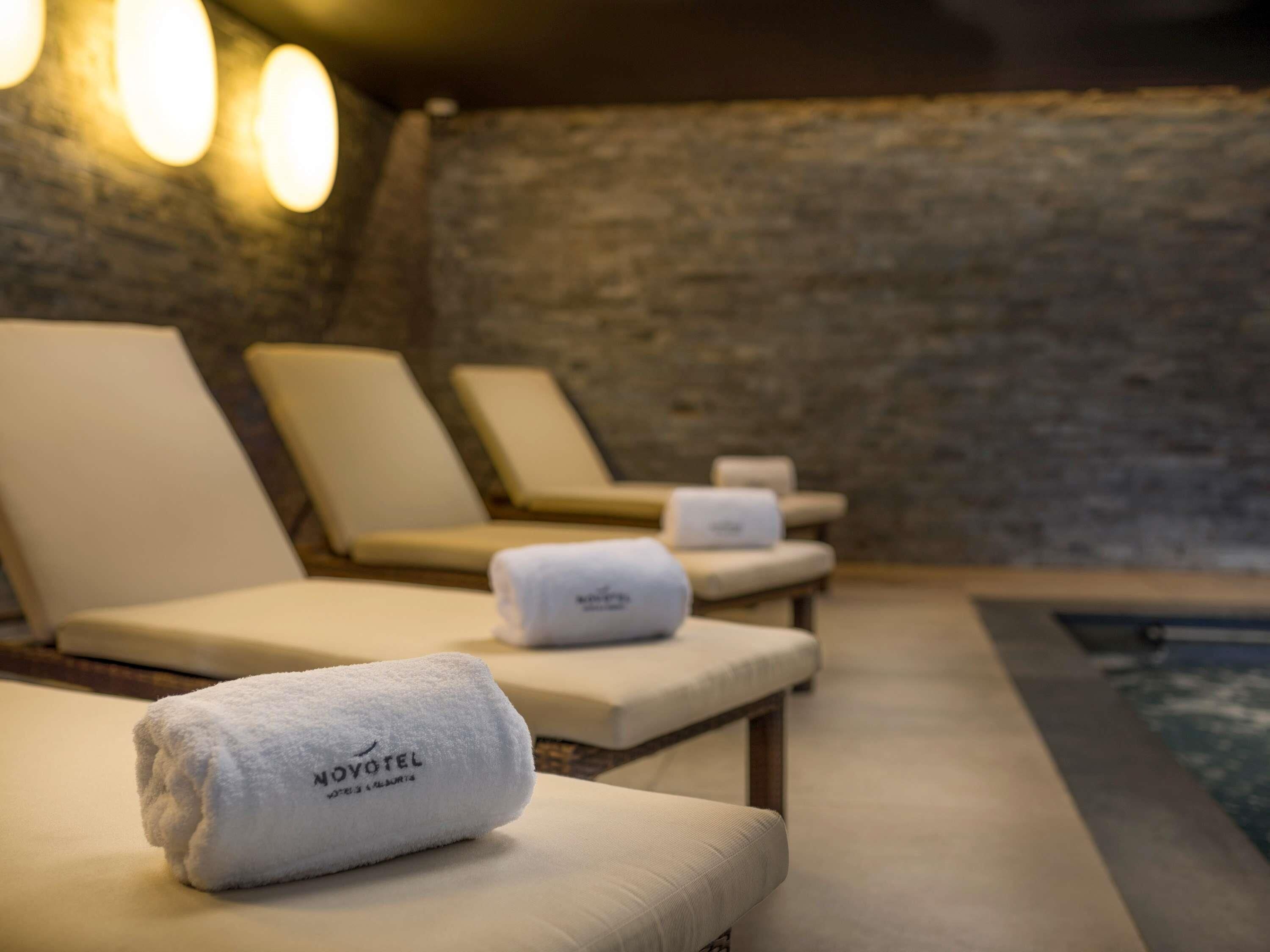 A spa area with reclining chairs and a towel on one of them.