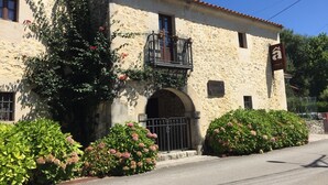 Un bâtiment en pierre doté d’un balcon, d’une enseigne indiquant « Posada El Lirio » et d’un portail en fer forgé.