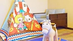 A children's play area with a colorful tent and a toy horse. - Jiangnanchun Hot Spring Resort Hotel (Zhengzhou)