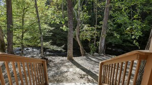 A wooden staircase leading into a forested area with a gravel path. - Wandering Creek - 2 Bedrooms, 1 Baths, Sleeps 6 Cabin by RedAwning (Cosby)