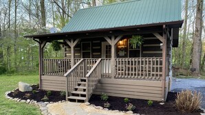 A cabin with a wooden deck, a staircase, and a porch. - Sweet - 2 Bedrooms, 2 Baths, Sleeps 6 Cabin by RedAwning (Cosby)