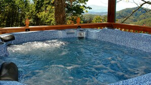 A hot tub with a wooden deck and a view of a forested mountain range. - Mountain View - 2 Bedrooms, 2 Baths, Sleeps 6 Cabin by RedAwning (Cosby)