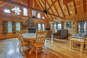 A spacious wooden cabin with a dining area, a fireplace, and a living room. - Mountain View - 2 Bedrooms, 2 Baths, Sleeps 6 Cabin by RedAwning (Cosby)