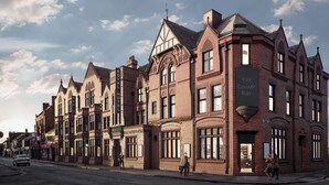 A row of traditional brick buildings with large windows and a corner bar. - The Royal Hotel Crewe, A BRILLIANT Collection (Crewe)