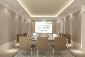 A conference room with a presentation screen, a long table, and chairs. - Arcade Hotel Istanbul (Istanbul)