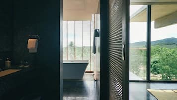 A modern bathroom with a bathtub, a toilet, and a sink.