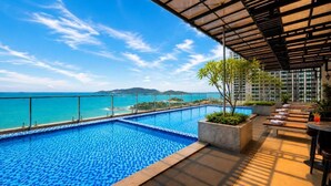 A rooftop pool with a view of the sea and mountains, surrounded by lounge seating and planters. - Hon Chong Retreat Hotel (Bac Nha Trang)