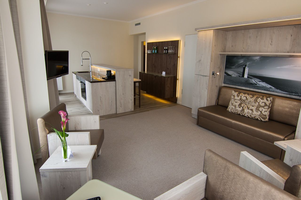 A modern living area with a sofa, a coffee table, and a TV mounted on the wall.