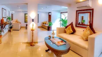A modern living room with a sofa, coffee table, and decorative items.