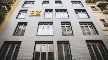 A building with a houndstooth pattern facade, multiple windows, and a prominent 'B3' sign above the entrance.