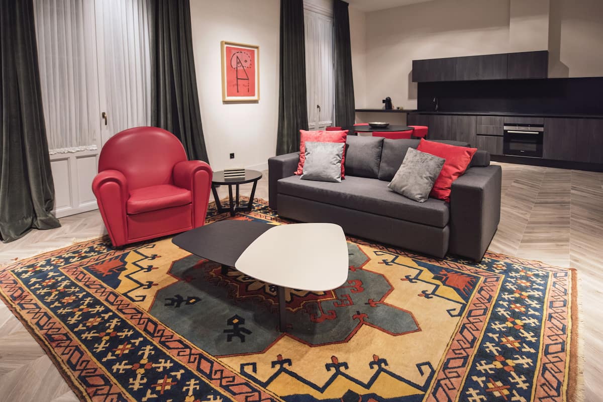 Luxury Suite, Balcony, City View | Living room | Flat-screen TV