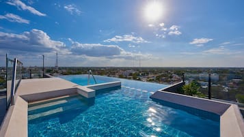 Outdoor pool, open 8:00 AM to 8:00 PM, pool umbrellas, pool loungers