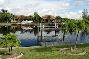 Enjoy waterfront views from this serene outdoor space with a dock and lush surroundings.