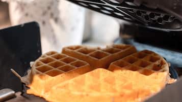 A waffle with a grid pattern, placed on a flat surface.