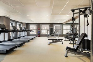 A gym with treadmills, weight machines, and dumbbells. - Hotel Northland, Autograph Collection (Green Bay)