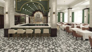 A bar area with a marble countertop, bar stools, and a wine rack. - Hotel Northland, Autograph Collection (Green Bay)