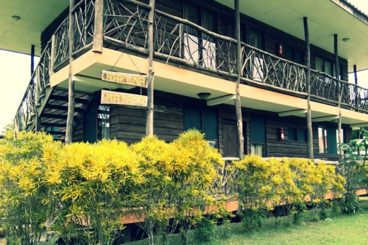A building with a balcony and a sign that reads "MATATA".