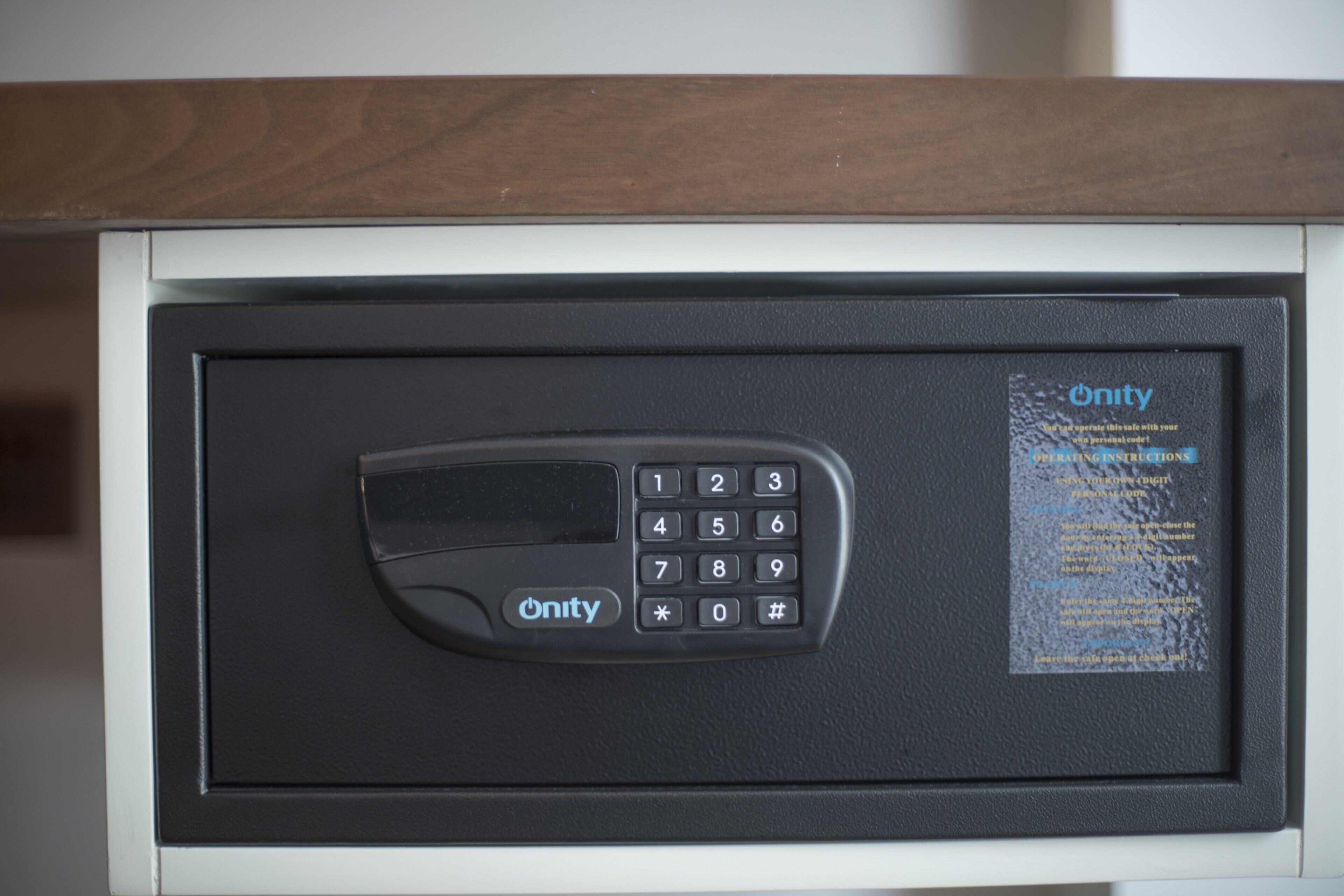 A security keypad with a 'Unity' brand label, a numeric keypad, and a small screen.