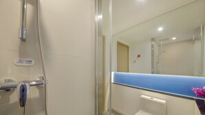 A bathroom with a glass shower enclosure, a toilet, and a sink with a blue countertop. - Holiday Inn Express Zhangjiagang East by IHG (Suzhou)