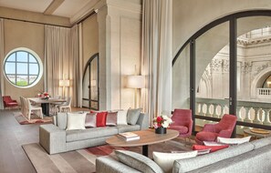 A spacious living room with a large window, a dining area, and a balcony with ornate railings. - Intercontinental Lyon Hotel Dieu by IHG (Lyon)