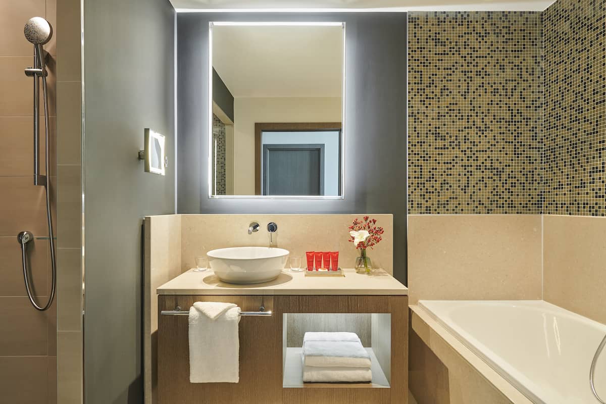 Combined shower/tub, designer toiletries, hair dryer, bathrobes