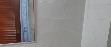 A bathroom with a white sink, a toilet, and a mirror above the sink.