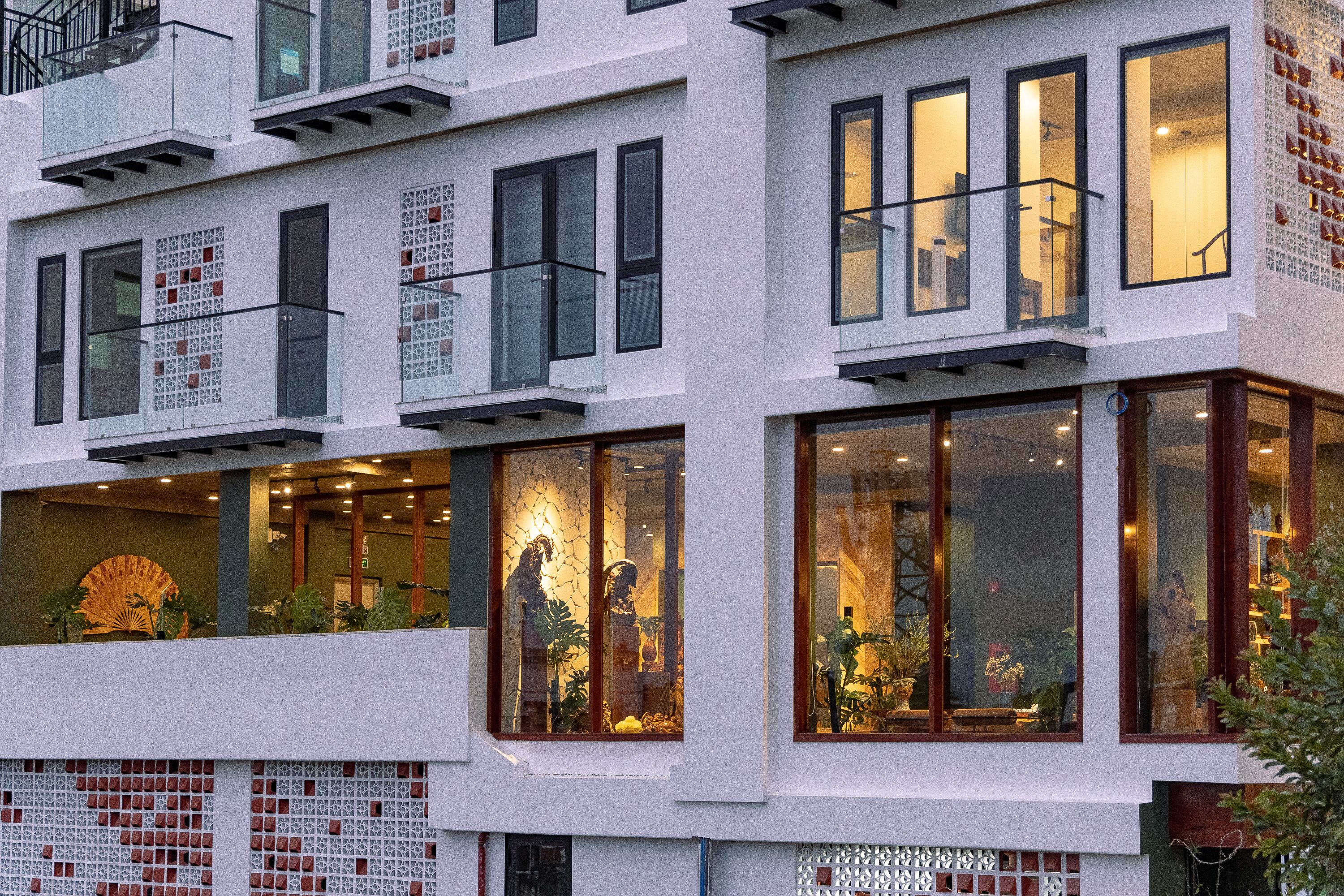 A multi-story building with large windows, balconies, and decorative patterns on the facade.