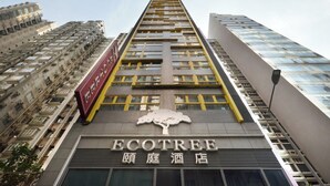 A tall building with the name "ECOTREE" and a tree logo on the facade. - Eco Tree Hotel Causeway Bay (Hong Kong)