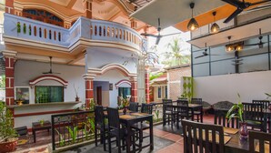 A restaurant with outdoor seating, multiple dining tables, and chairs. - Golden Ganesha Villa - Hostel (Siem Reap)