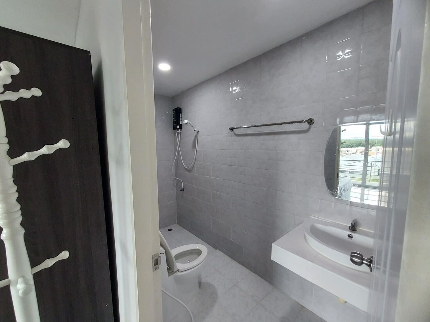 A modern bathroom with a toilet, sink, and shower.