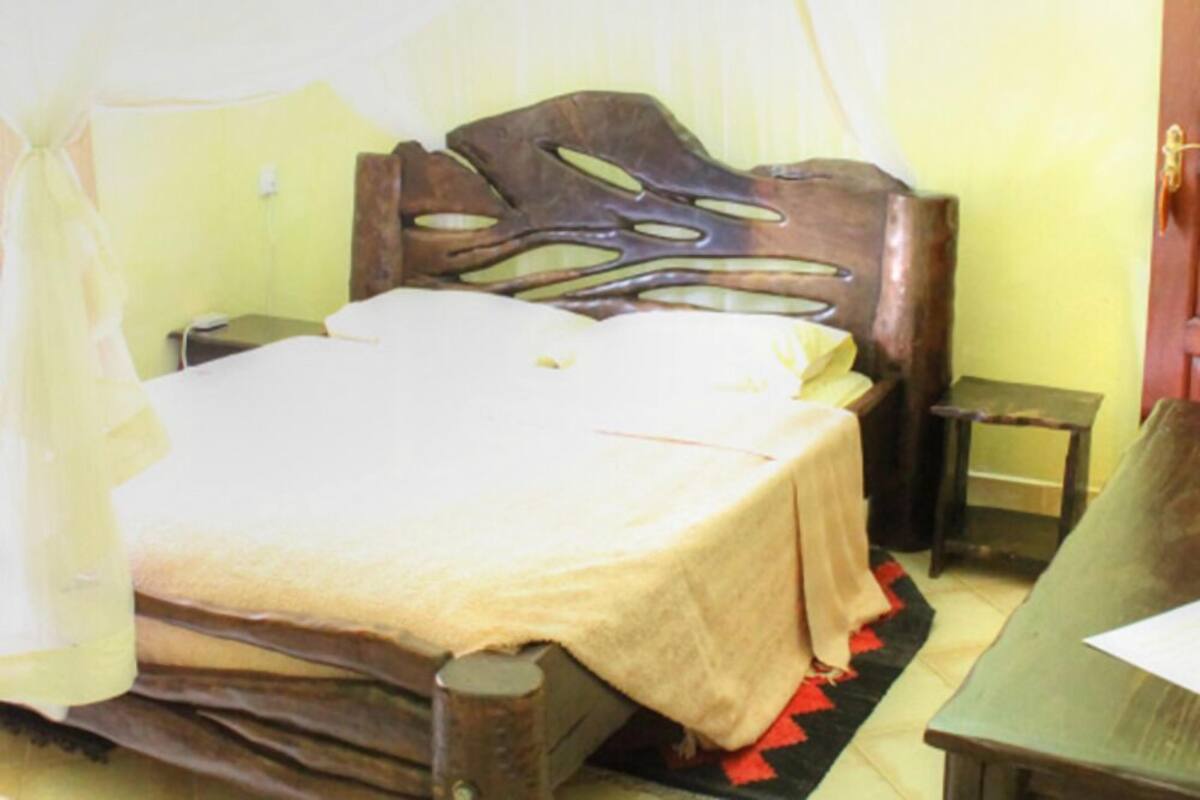 Ein Zimmer mit Bett, Nachttisch und Beistelltisch.