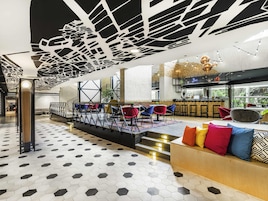 A modern interior with a bar area, seating, and a staircase.