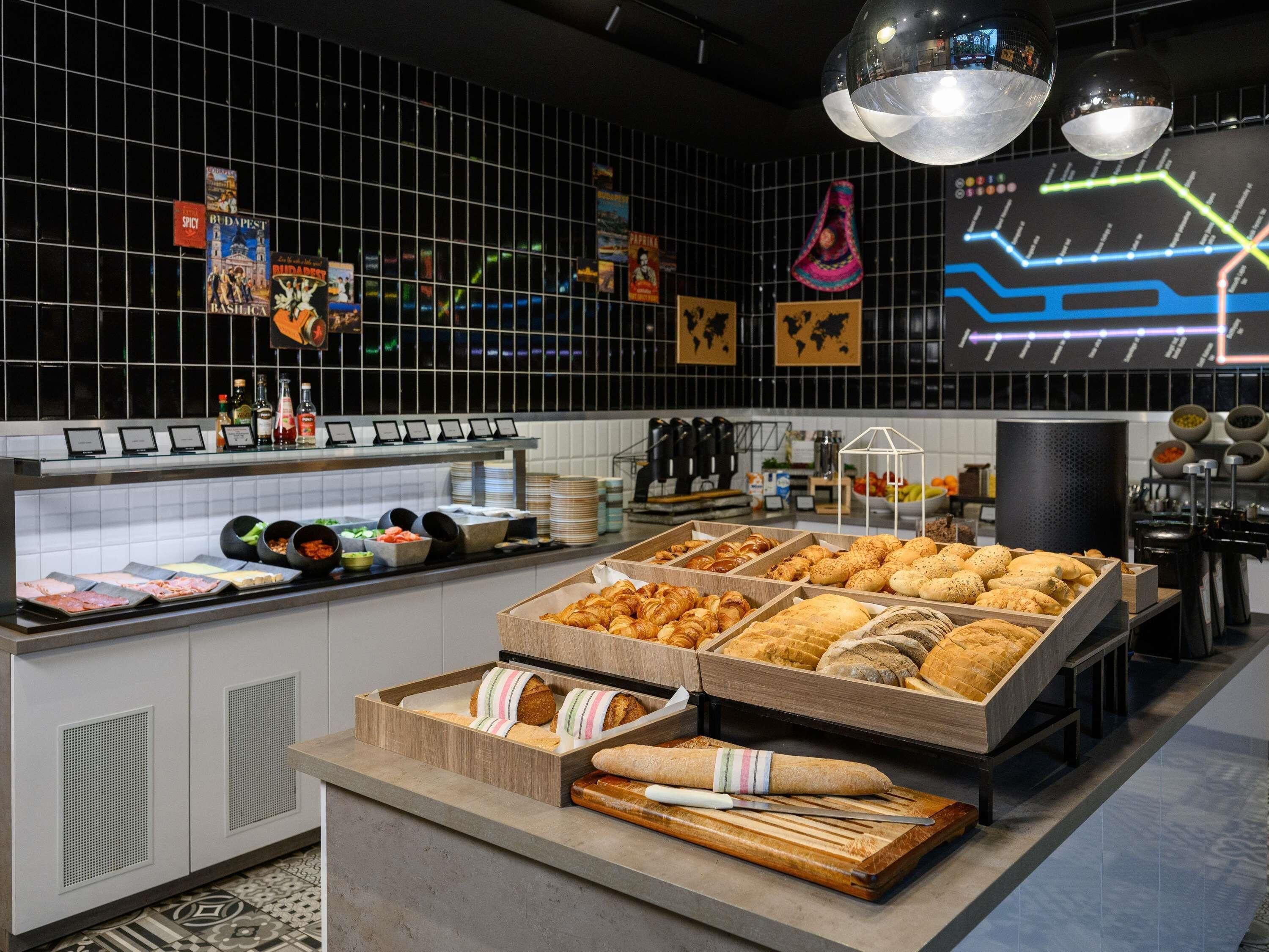 A bakery counter with various baked goods and a selection of beverages.