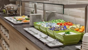 A buffet setup with various food items and utensils. - Holiday Inn Express Wuppertal - Hauptbahnhof by IHG (Wuppertal)