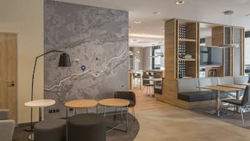 Ein modernes Interieur mit einer Wandkarte, Sitzgelegenheiten und einem Bücherregal.