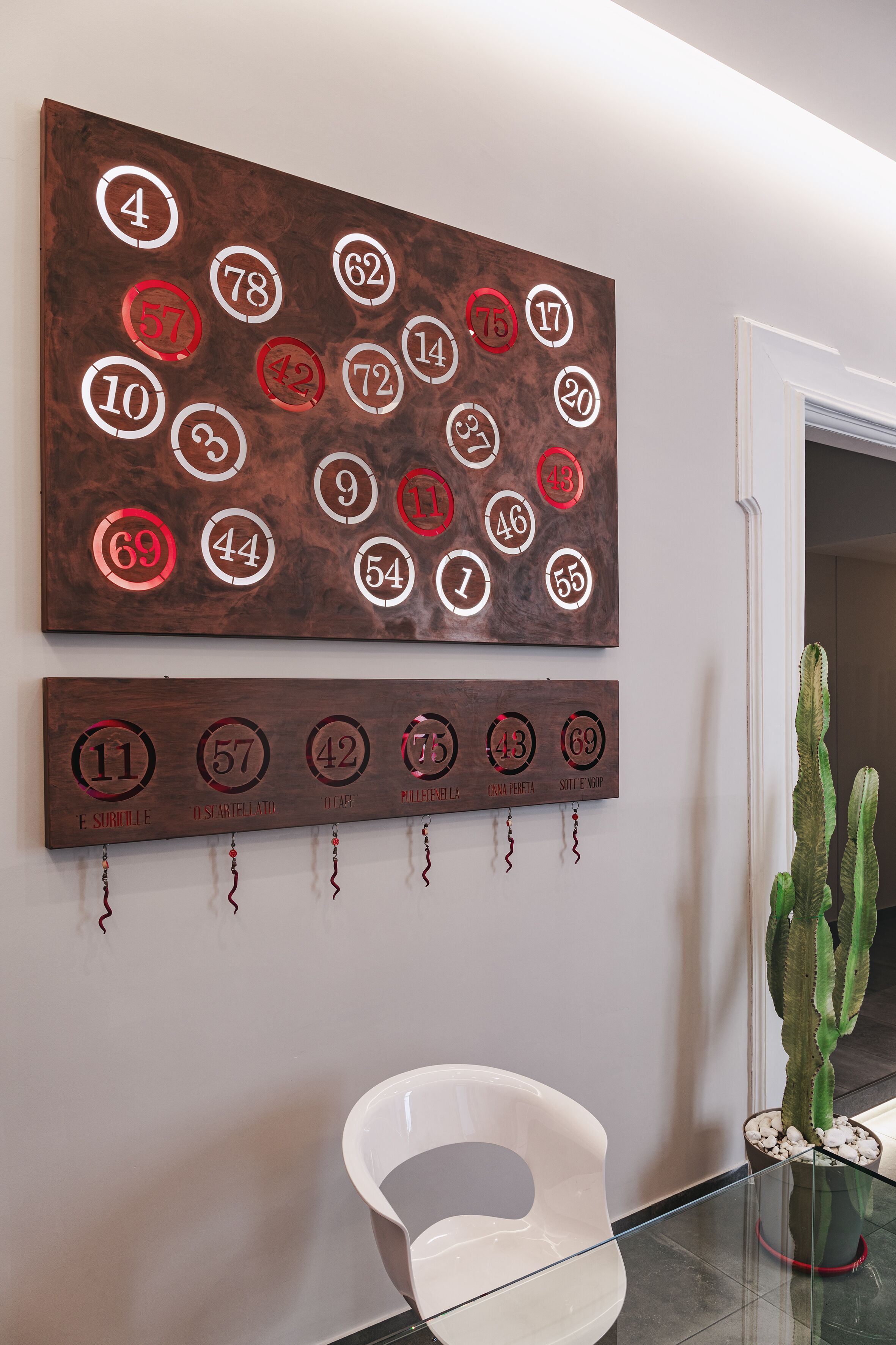 A wall with numbered plaques and a lower plaque with text.