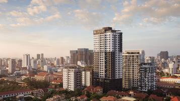 A high-rise building with a modern design, surrounded by other buildings in an urban setting.