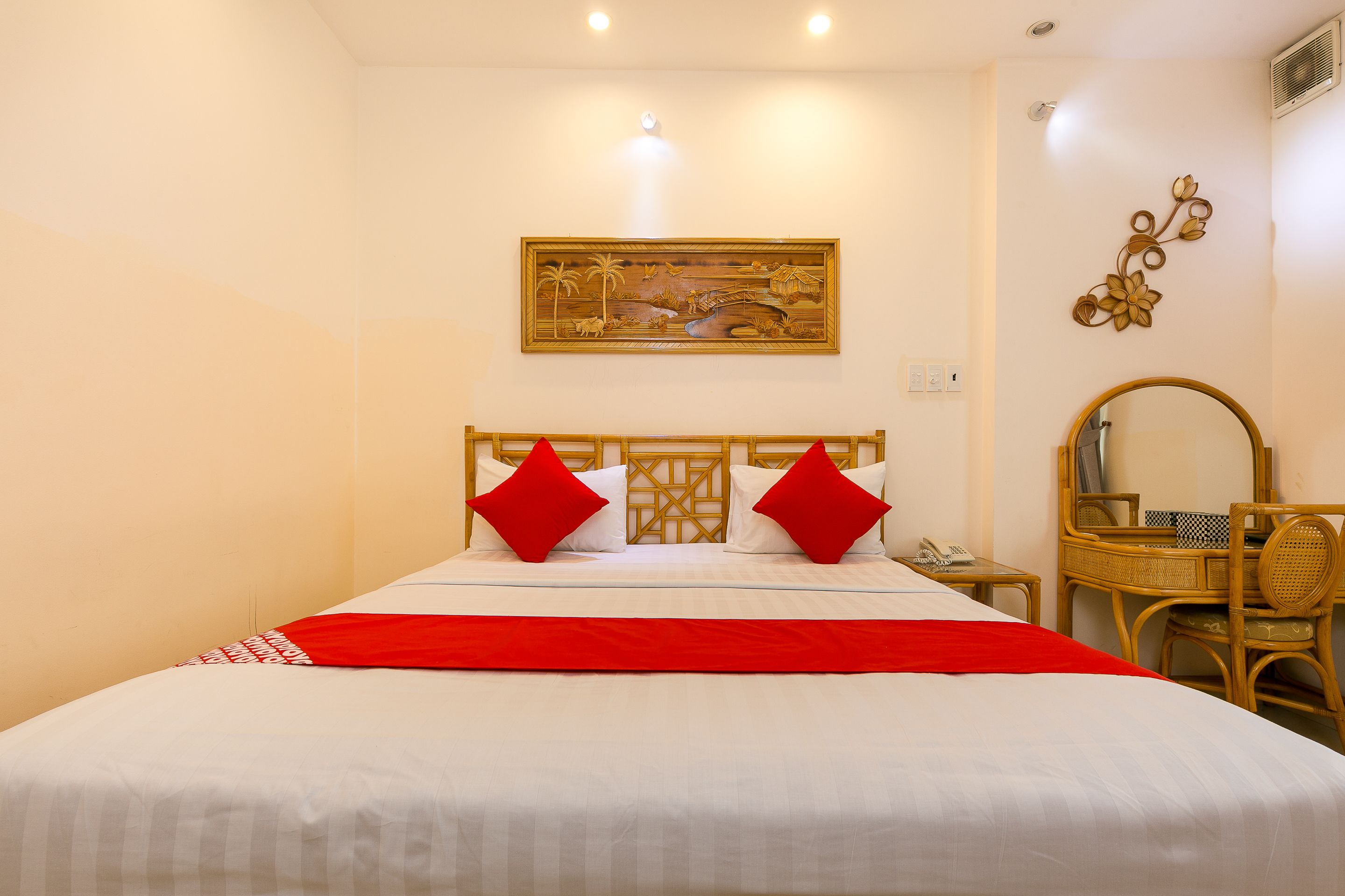 A hotel room with a bed, a desk, and a chair.