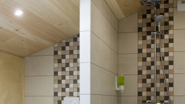 A modern bathroom with a shower, toilet, and a small trash bin. - Le Puy Carmin - Chambres D'hôtes (Bazoges-en-Paillers)