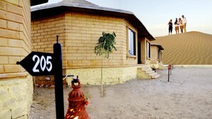 A building with a number sign '205' and a red fire hydrant in front. - Shiv Tara Desert Camp (Jaisalmer)