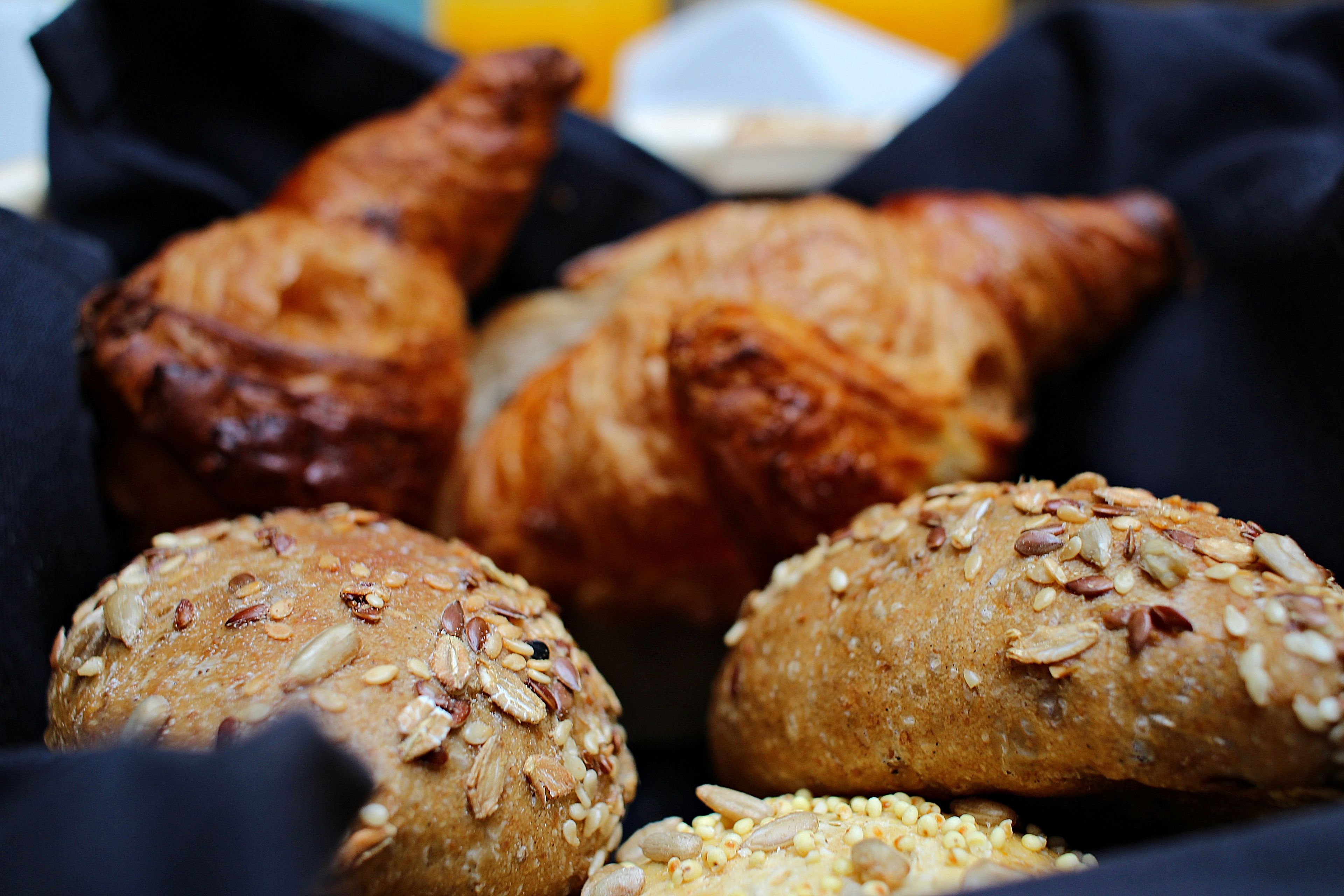 A basket containing various baked goods, including bread and pastries.